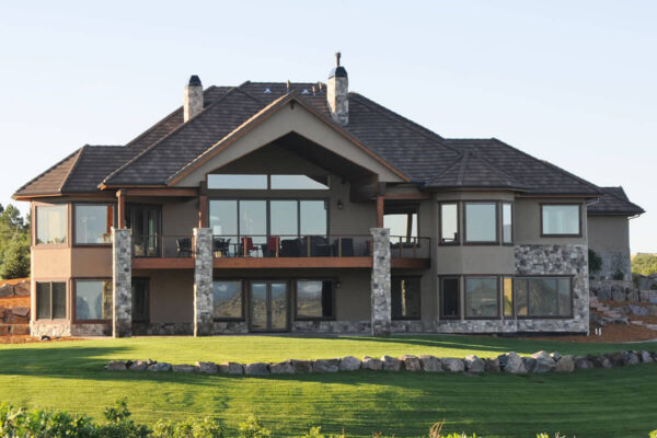 Backyard view of two beautiful two store home with stone and stucco in Douglas County (Colorado).
