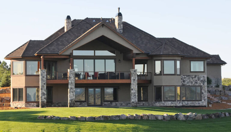 Backyard view of two beautiful two store home with stone and stucco in Douglas County (Colorado).