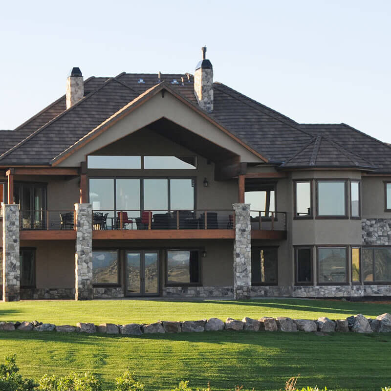 Backyard view of two beautiful two store home with stone and stucco in Douglas County (Colorado).
